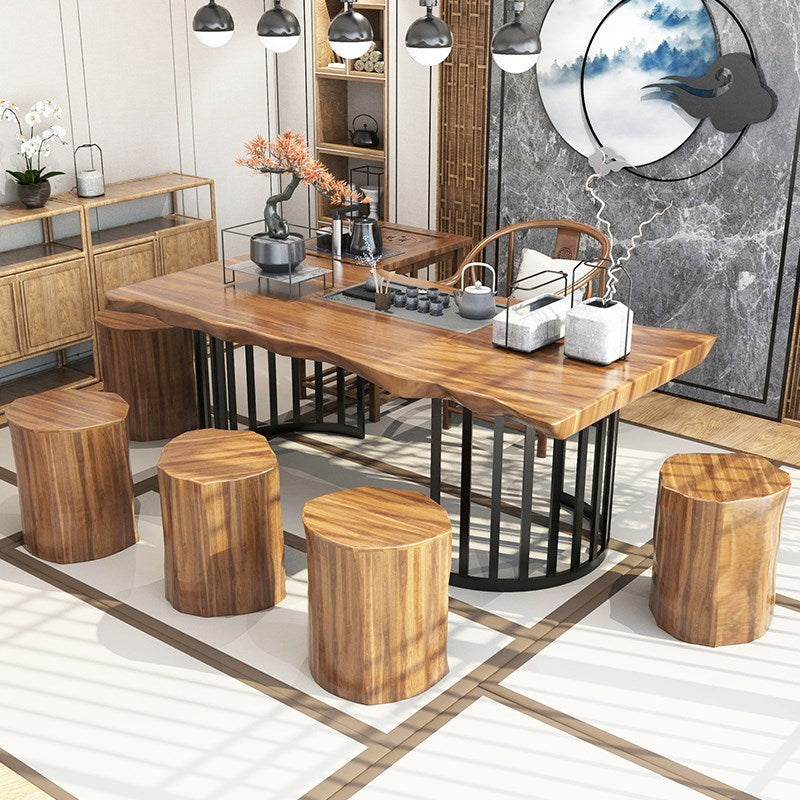 Side angle of a large tea table for living room with natural wood texture and comfortable stools.