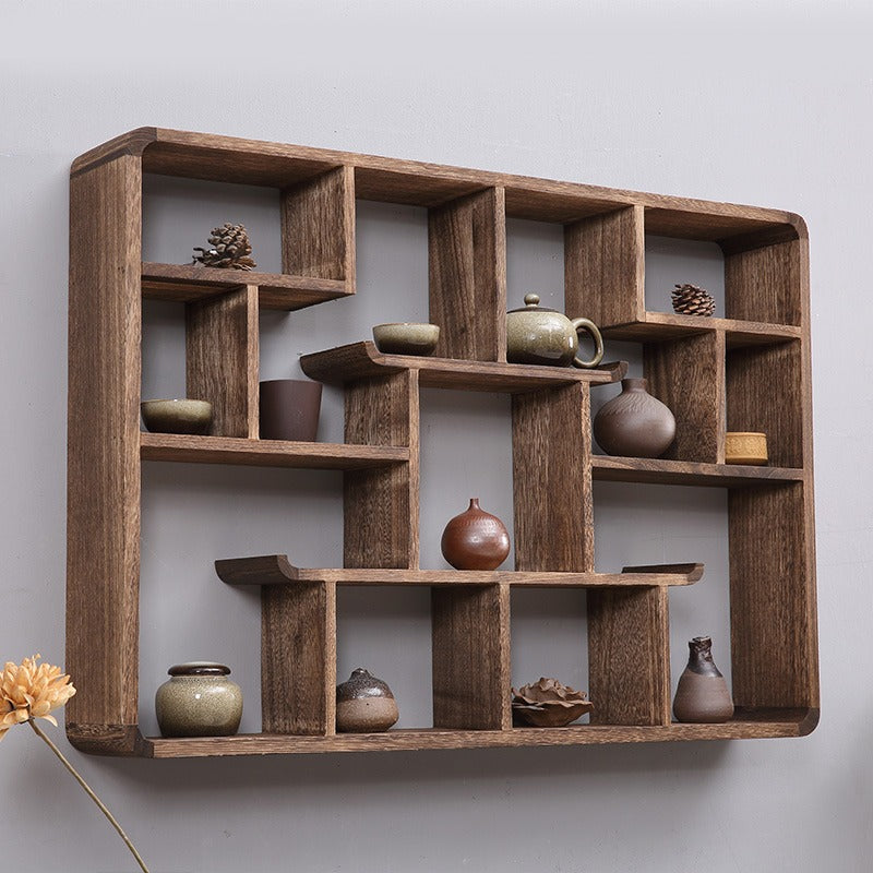Elegant wall hanging curio cabinet displaying collectibles in a cozy living room.