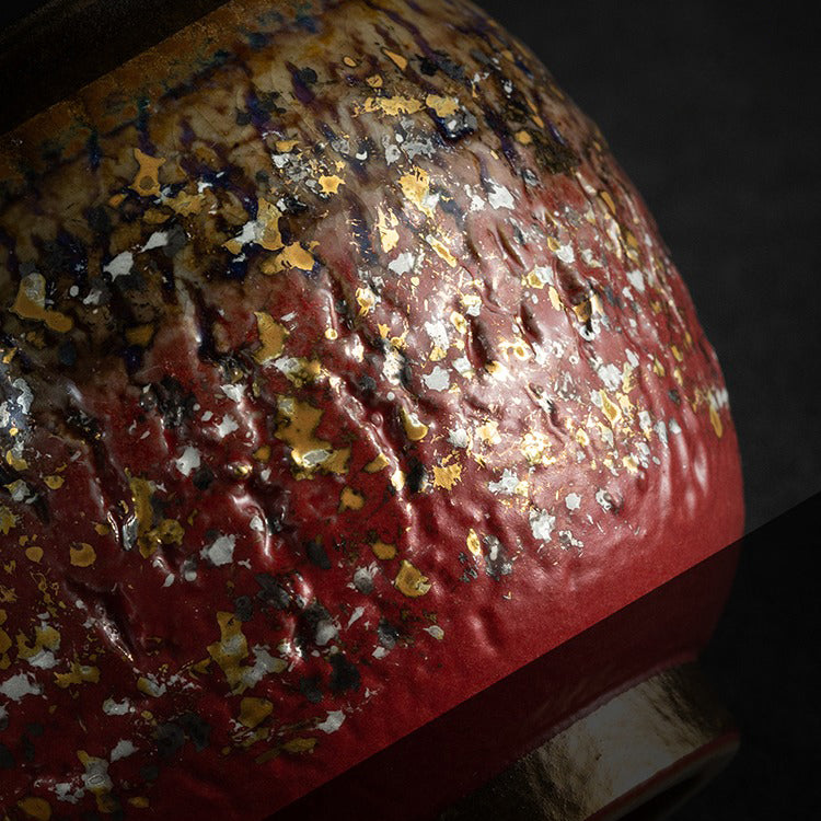 Tea cup set on a wooden table, highlighting its luxurious gold finish.
