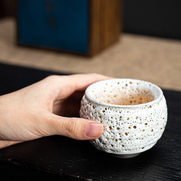 Close-up view of the antique style ceramic tea cup with a luxurious gold glaze.