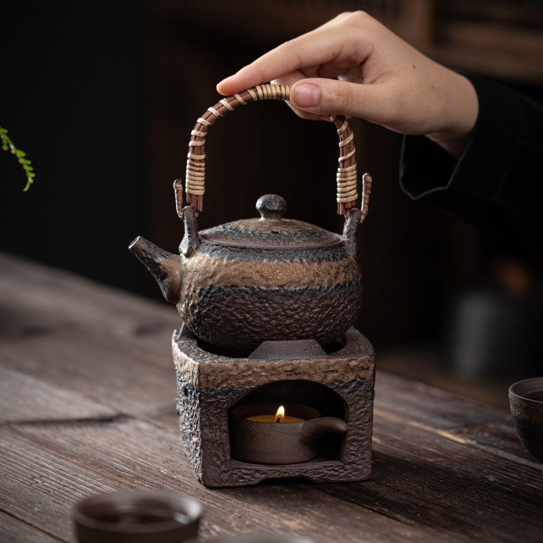 Using the clay teapot warmer to keep tea hot on a cozy table setting