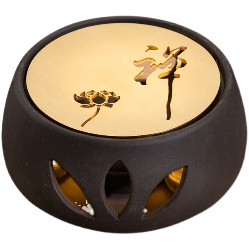 Close-up of the clay teapot warmer demonstrating the candle spoon pad and heat sink.