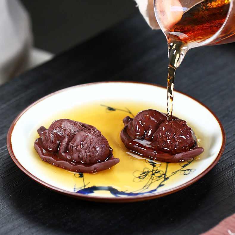 Charming Monkey Tea Pet on Bodhi Leaf, showcasing its intricate design and lifelike features.
