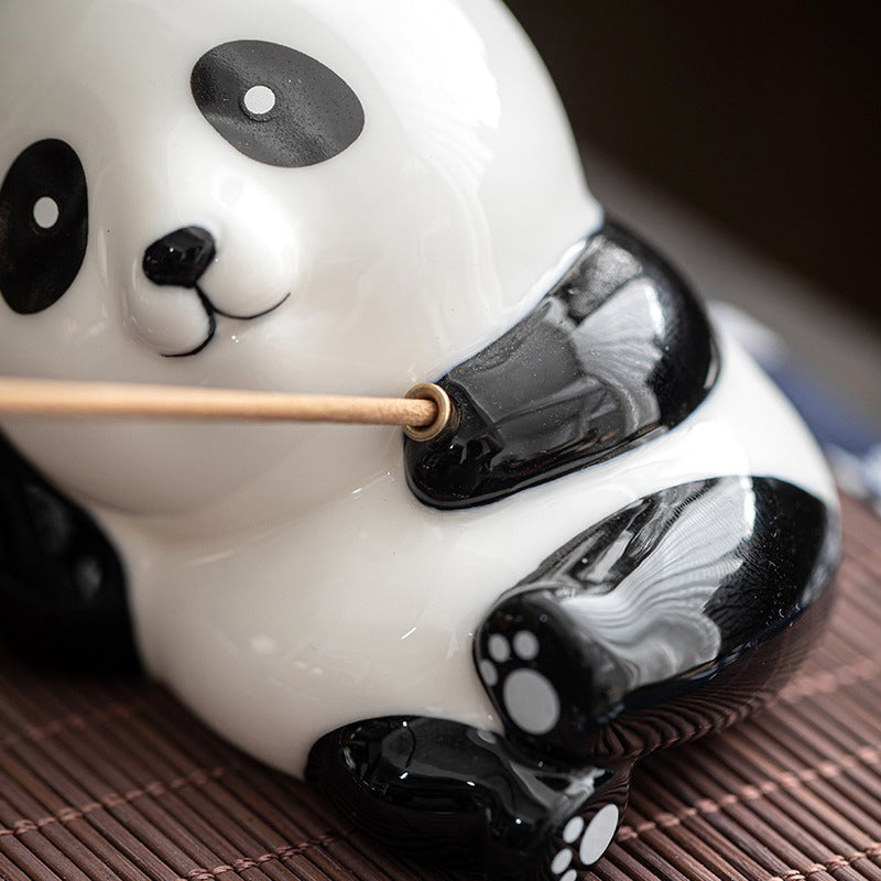 Close-up of porcelain panda tea pet showing detailed craftsmanship and glossy finish