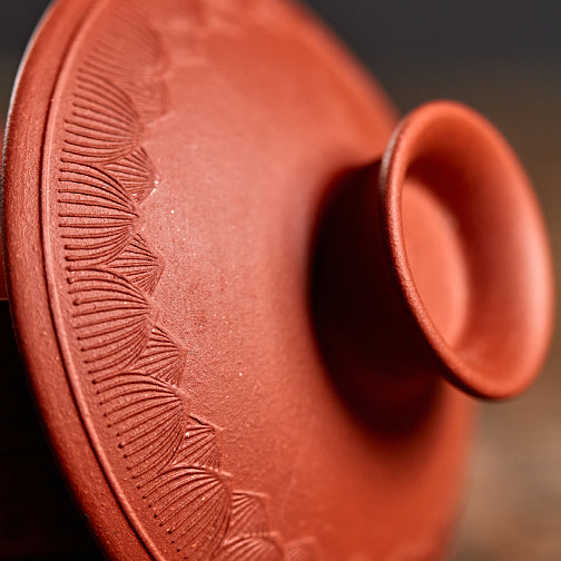 Close-up of the Heart Sutra Yixing clay gaiwan highlighting its engraved design.