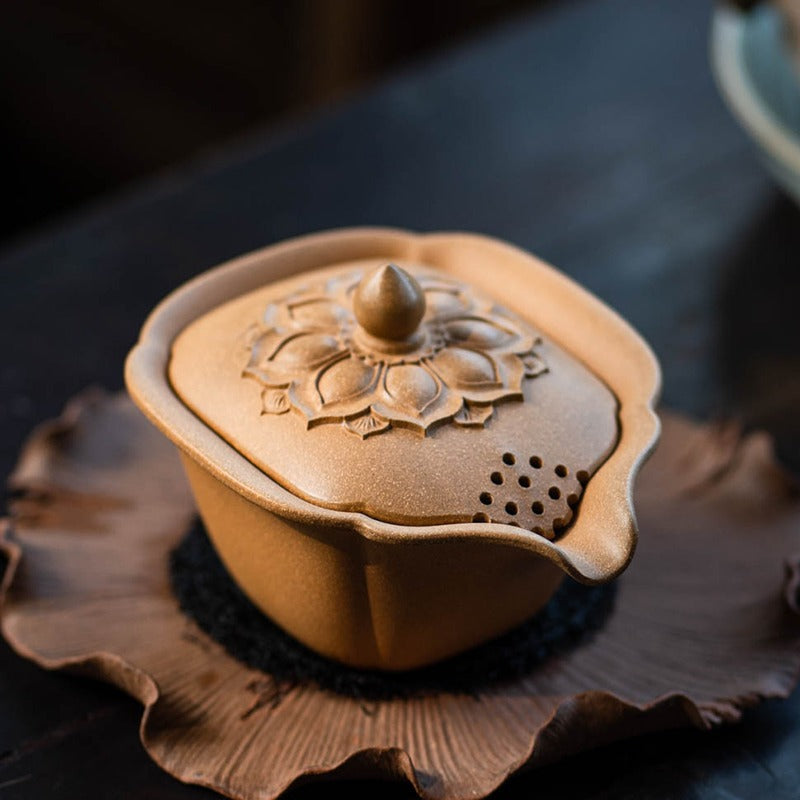 Elegant view of the Yixing clay teapot with intricate lotus lid design.