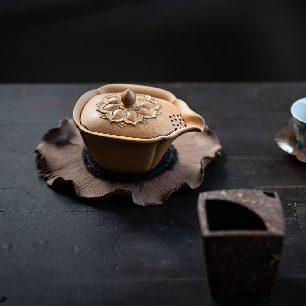 Elegant view of the Yixing clay teapot with intricate lotus lid design.
