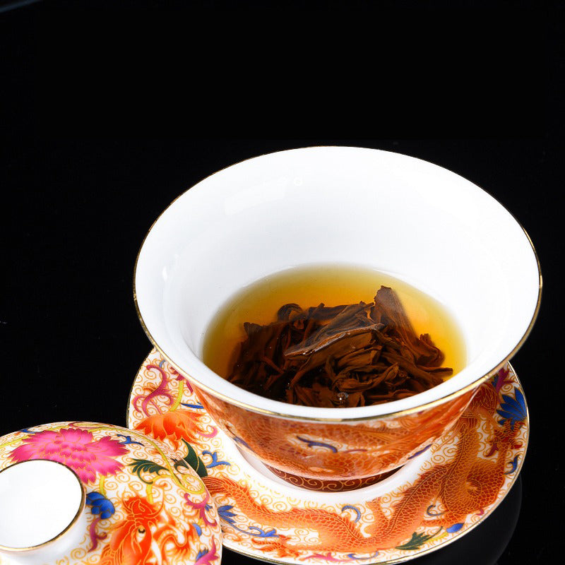 Elegant enamel porcelain gaiwan showcasing intricate dragon phoenix design from the side.