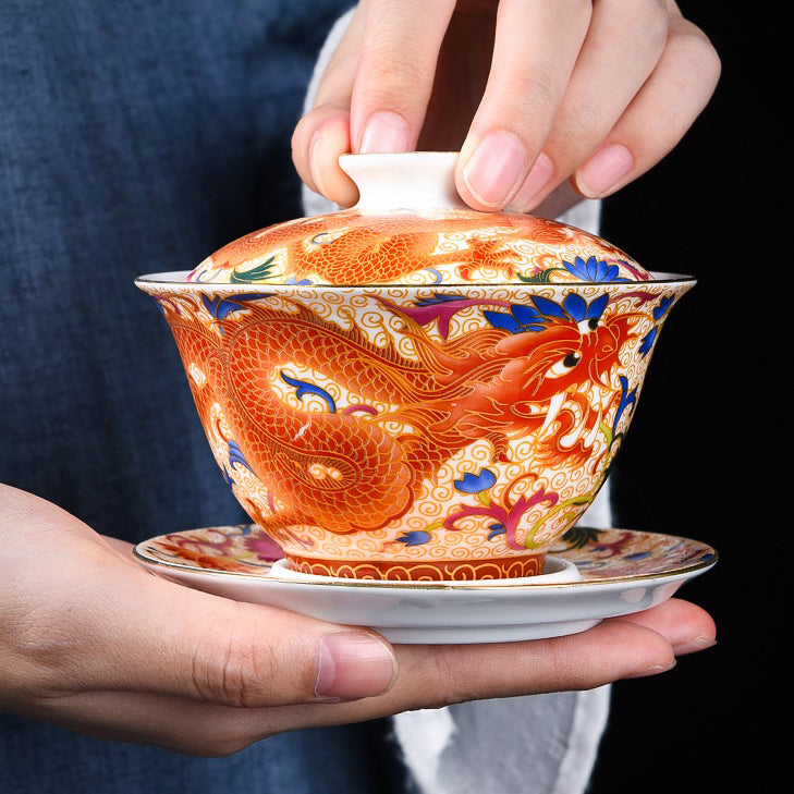 Elegant enamel porcelain gaiwan showcasing intricate dragon phoenix design from the side.
