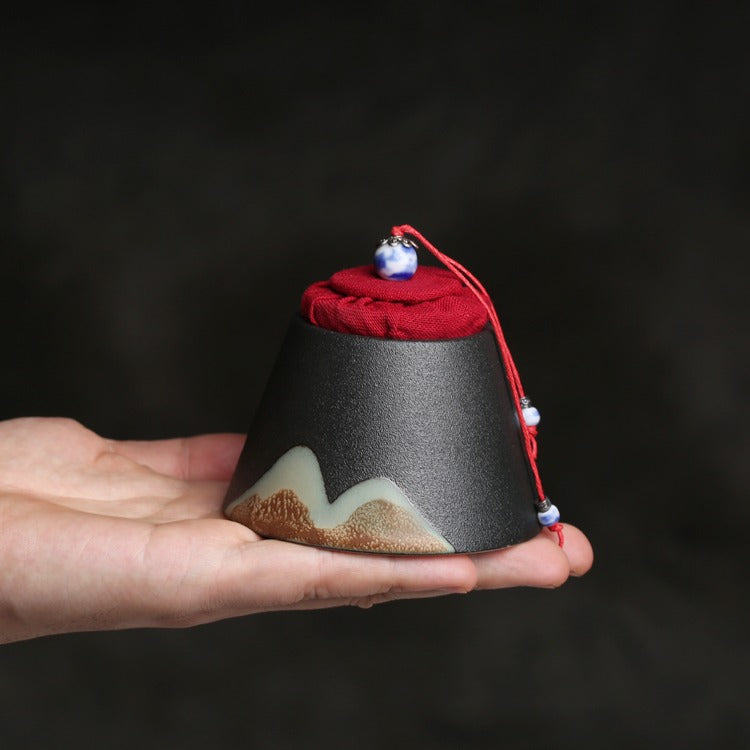 Mountain-Style Japanese Ceramic Tea Caddy from a side angle, showcasing its elegant shape and texture.