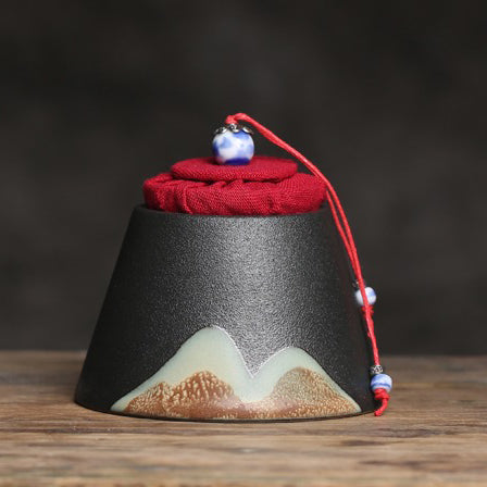 Mountain-Style Japanese Ceramic Tea Caddy from a side angle, showcasing its elegant shape and texture.