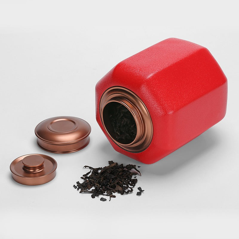 Ceramic tea caddy with red palace lantern design on countertop