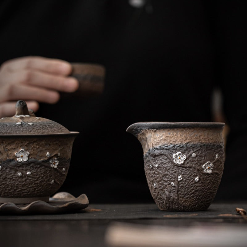 Side view of the unique rock clay tea cup with gilt rust glaze