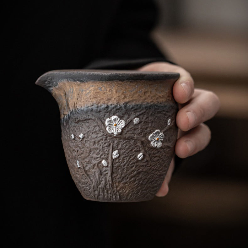 Side view of the unique rock clay tea cup with gilt rust glaze