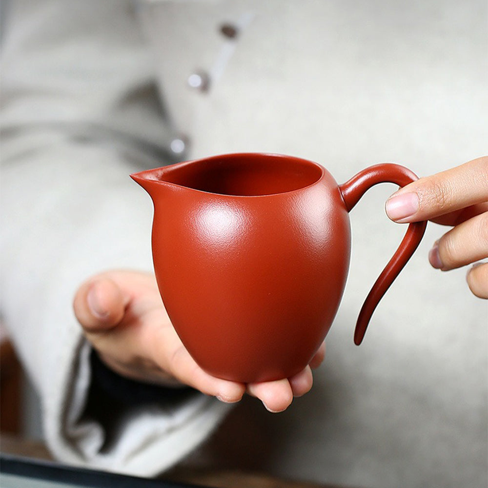 Large Yixing fair cup filled with freshly brewed tea, perfect for tea ceremonies.
