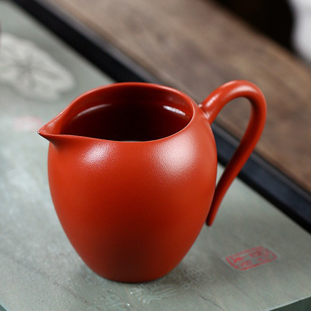 Close-up of the lotus pattern on the Yixing red clay tea cup, highlighting the craftsmanship.