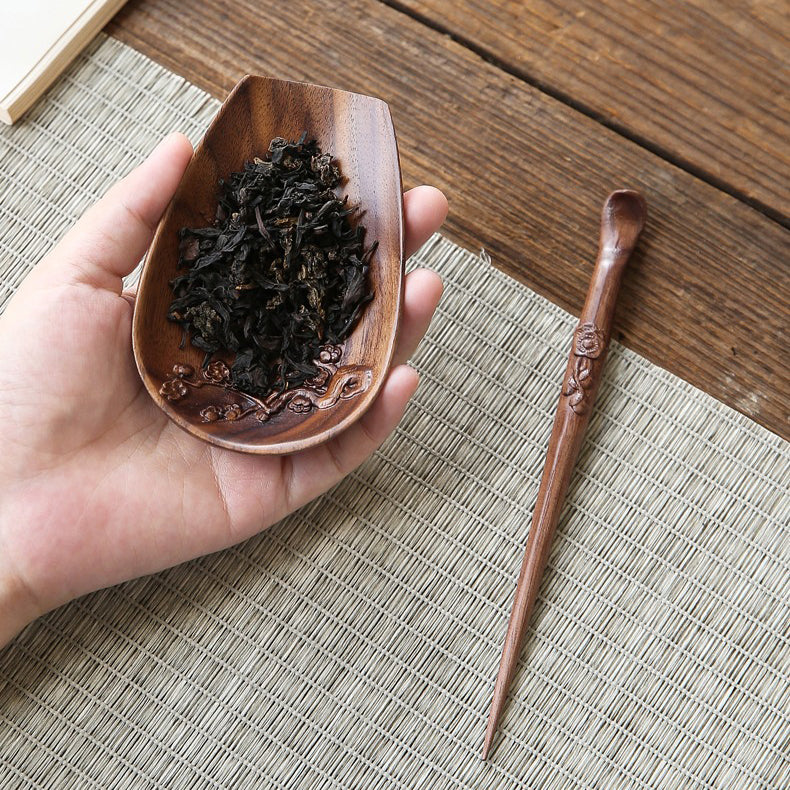 Close-up of walnut wood tea holder with tea needle showing detailed craftsmanship