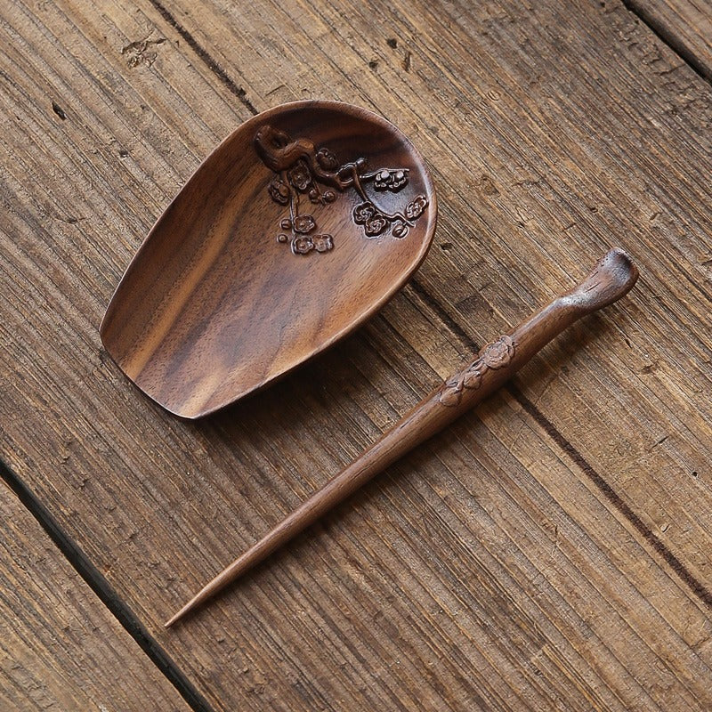 Close-up of walnut wood tea holder with tea needle showing detailed craftsmanship