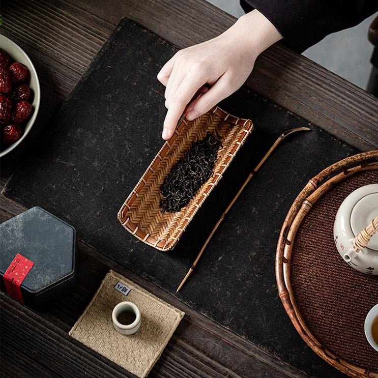 Tea holder with spoon in use during a tea ceremony, highlighting its functionality and aesthetic appeal.
