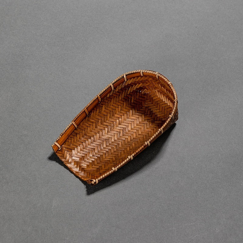 Tea holder with spoon in use during a tea ceremony, highlighting its functionality and aesthetic appeal.