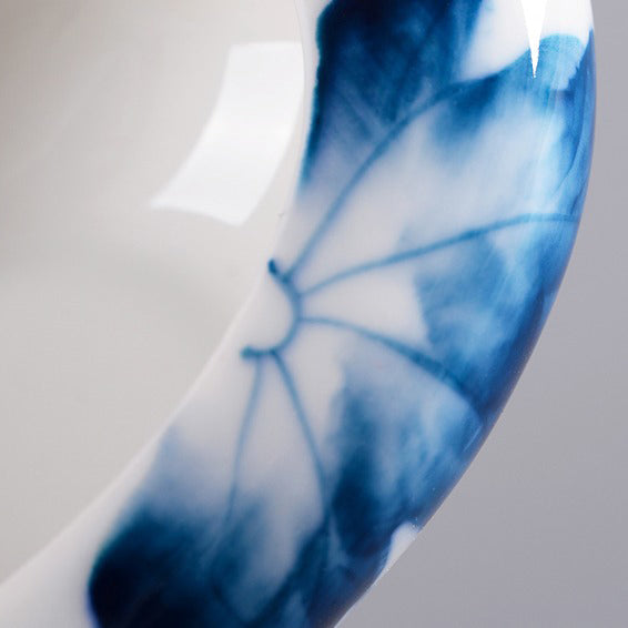 Close-up of hand-painted lotus porcelain cha he showcasing intricate details