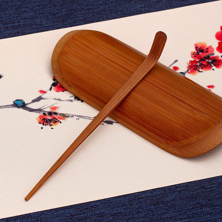Bamboo tea holder with needle used for brewing tea.