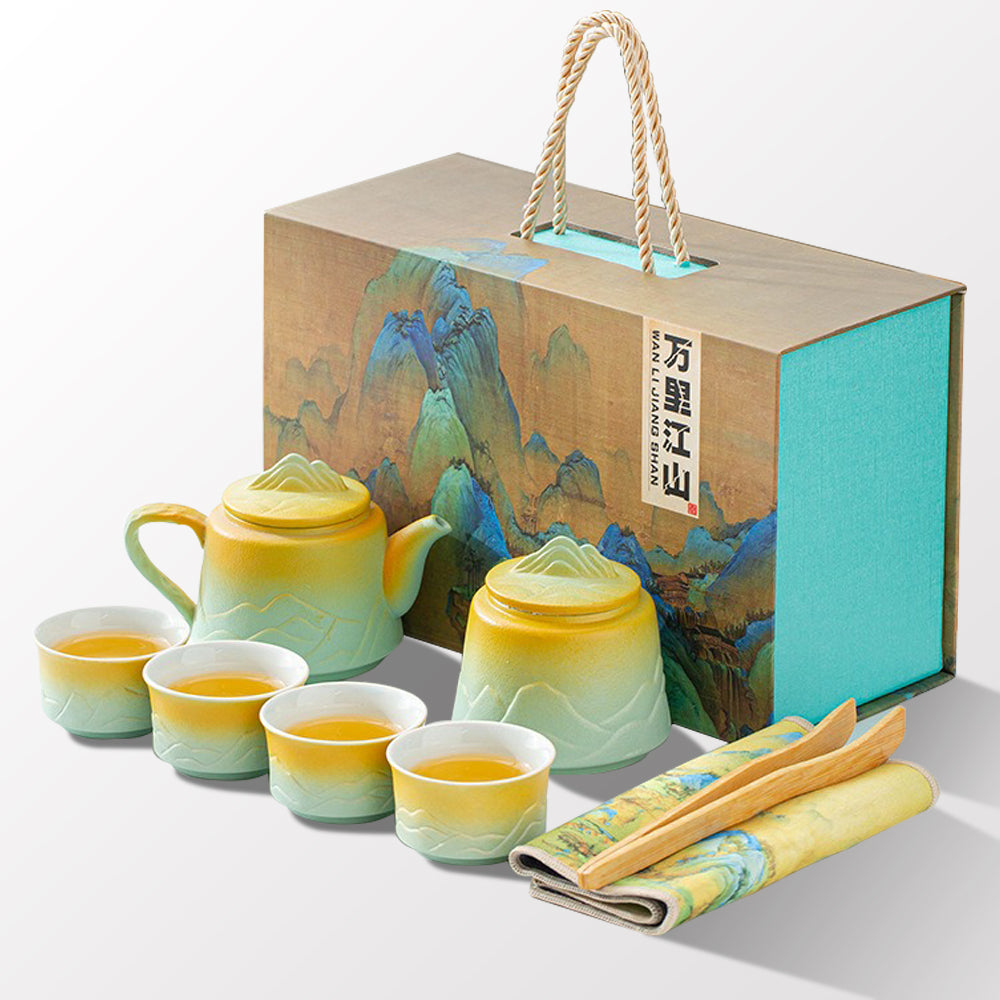 Close-up of mountain and river themed ceramic tea set showcasing vibrant glaze