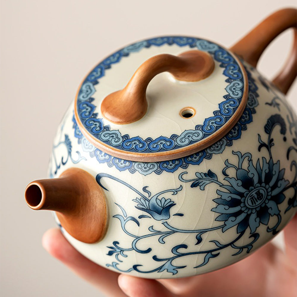 Close-up of blue and white ceramic teapot with crackle glaze and floral patterns