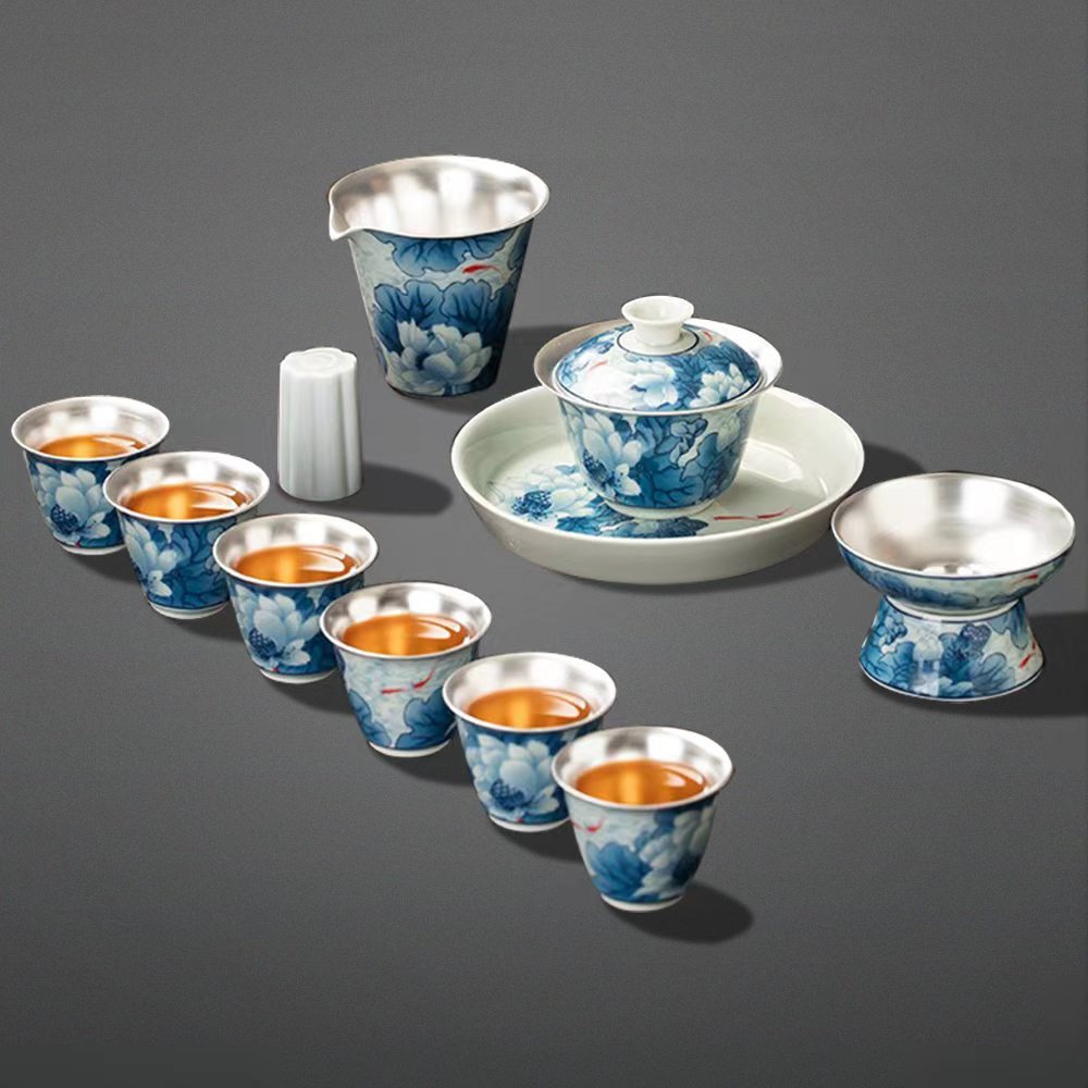 Elegant Silver-Plated Lotus Porcelain Tea Set displayed on a wooden table, highlighting its intricate lotus patterns.
