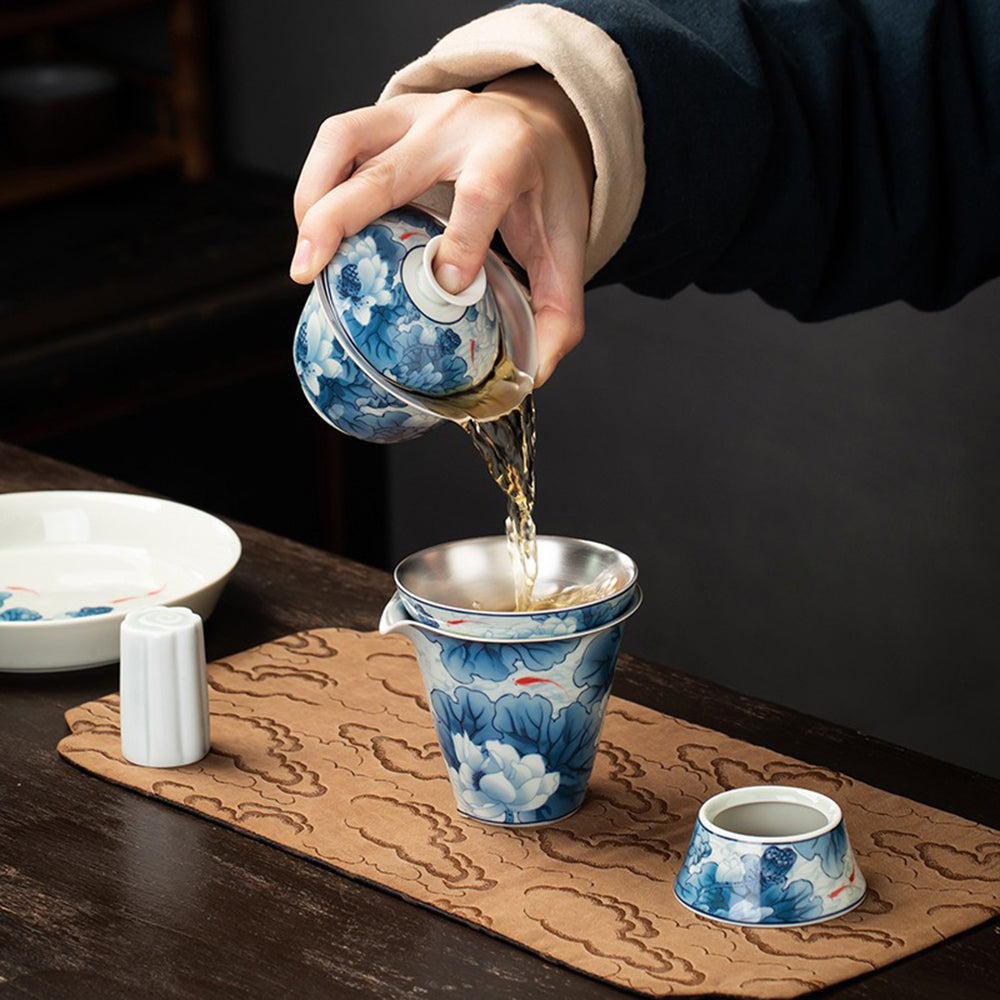 Close-up of the tea cups from the Elegant Silver-Plated Lotus Porcelain Tea Set, showcasing the silver plating and lotus design.