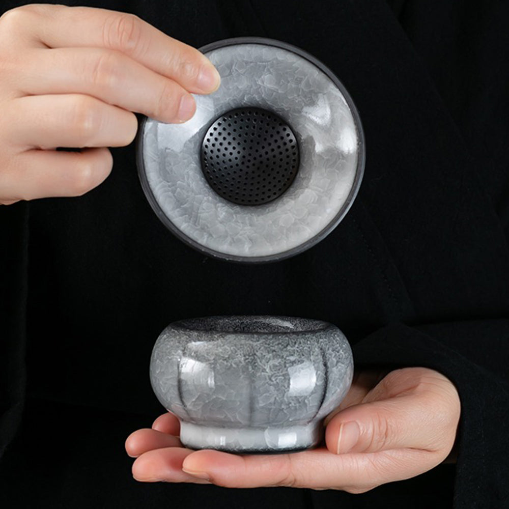 Detailed view of the black ice crack tea cup, showcasing its unique design.