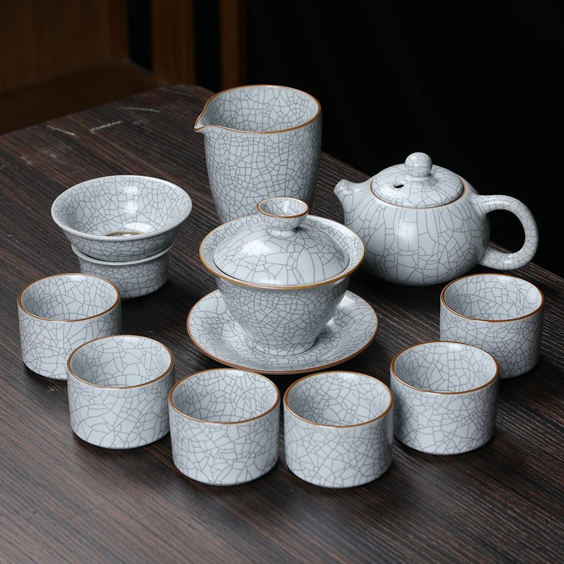 Milky white Ruyao tea set displayed elegantly on a wooden table.