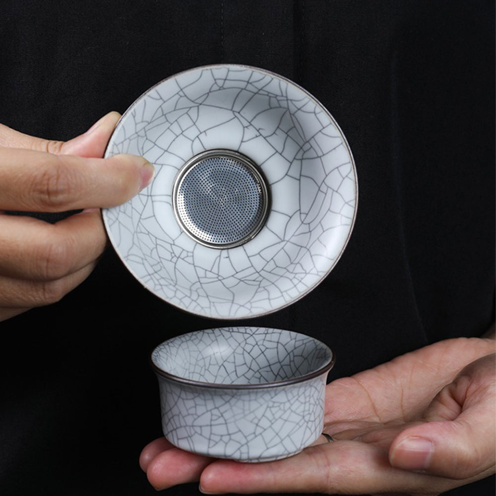 Milky white Ruyao tea set displayed elegantly on a wooden table.