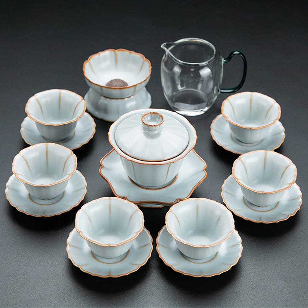 Close-up of handcrafted porcelain flower-shaped tea set with gaiwan and saucers, highlighting detailed craftsmanship