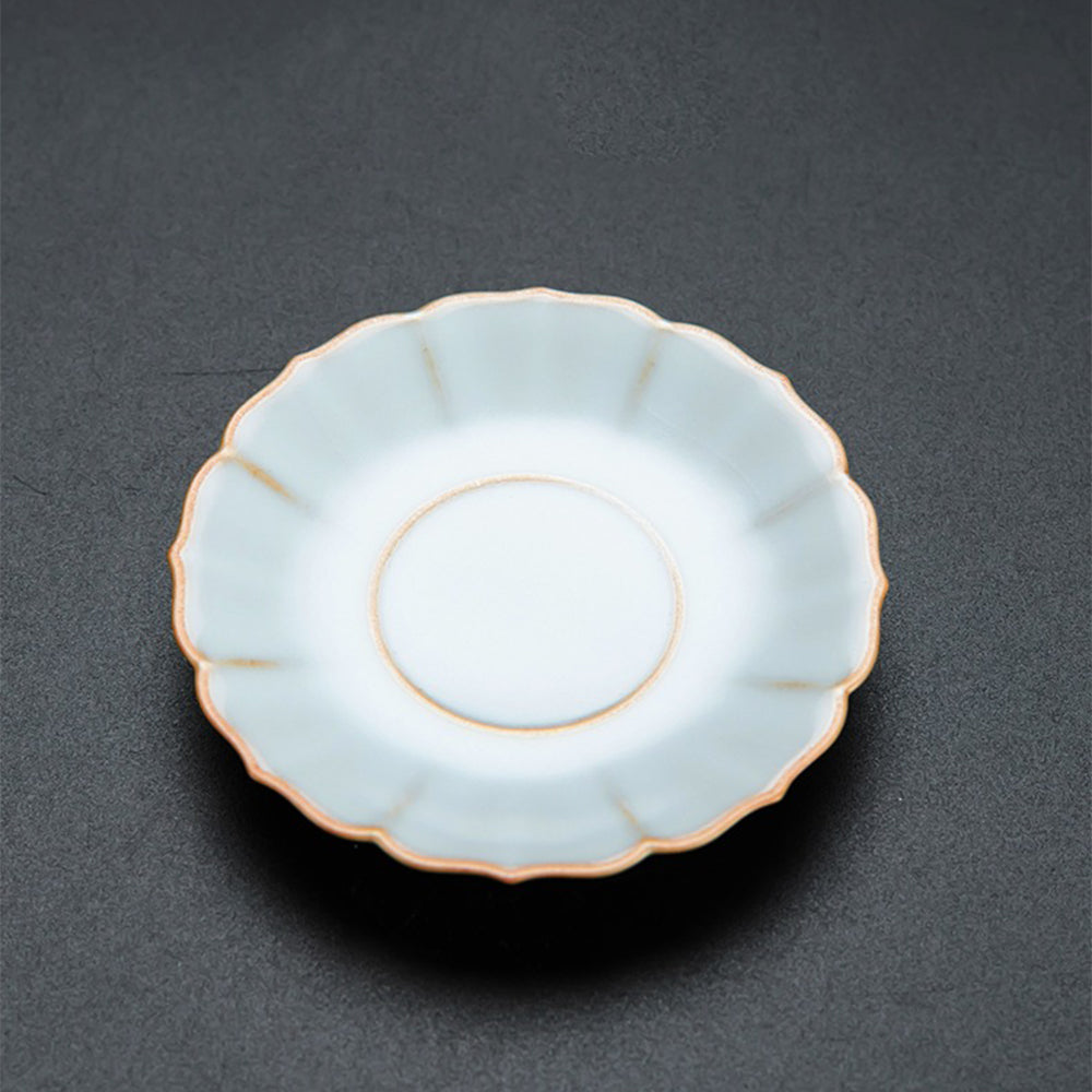 Set of elegant flower tea set with gaiwan, tea cups, and saucers displayed on a wooden table, perfect for home decor
