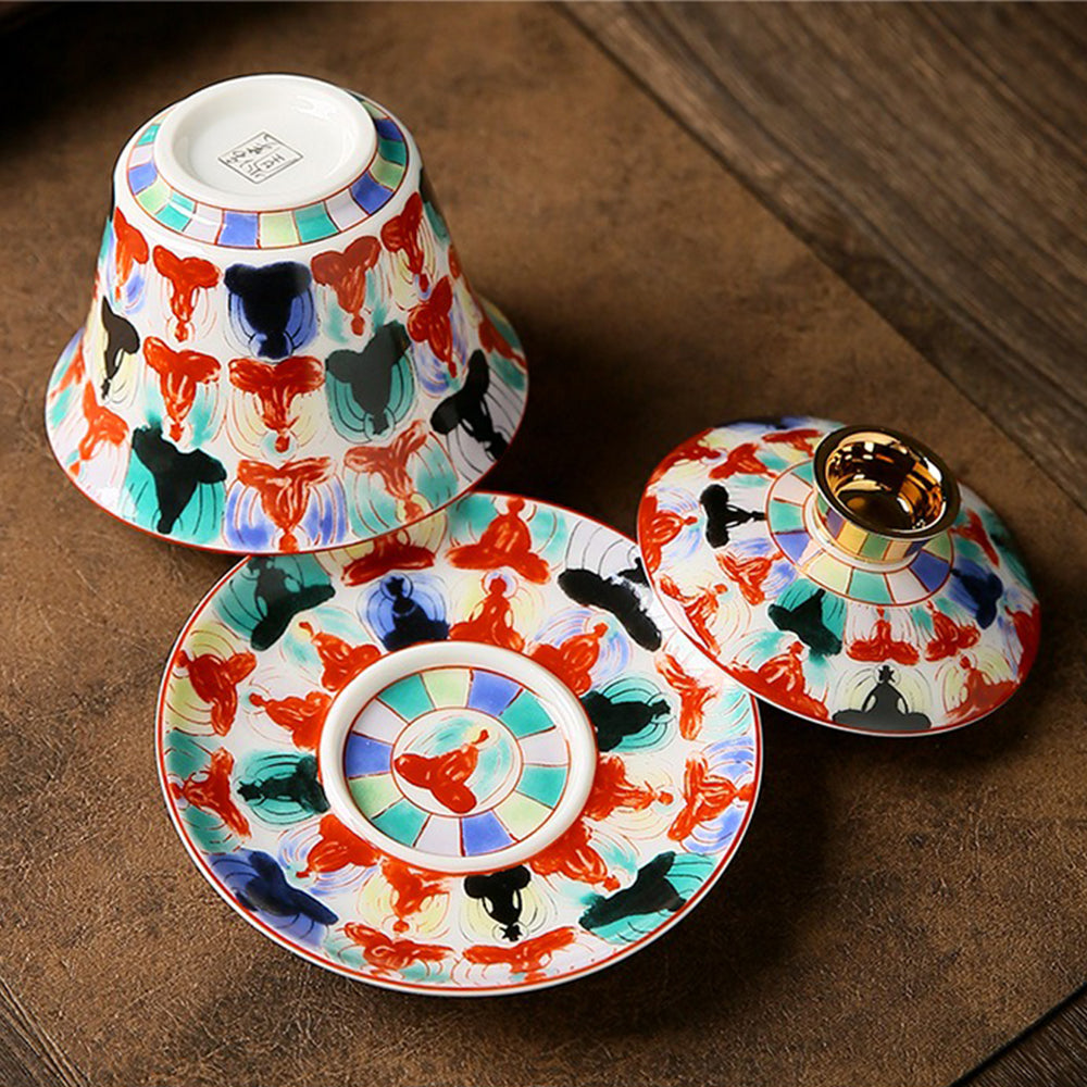 Elegant Buddha porcelain gaiwan set with intricate patterns, ideal for tea brewing.