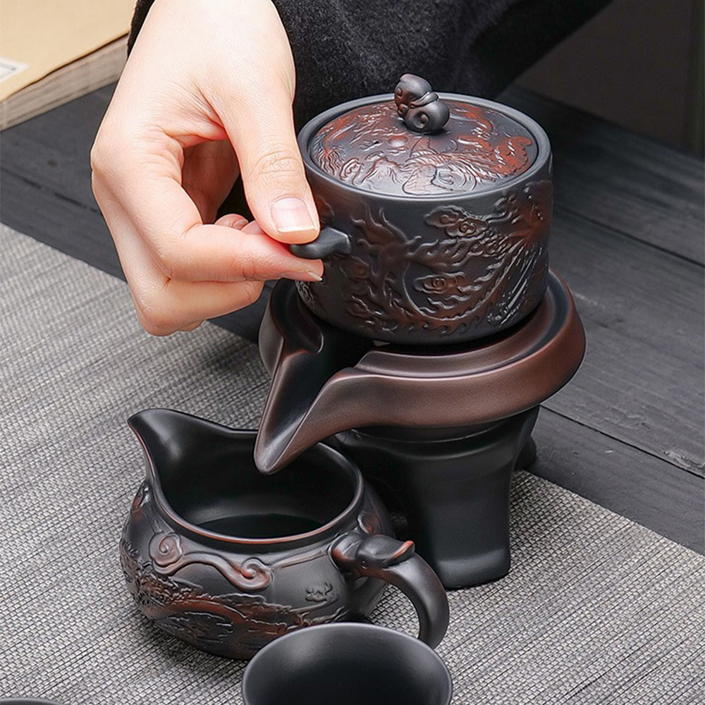 Automatic tea set in use, pouring tea with dragon handle fair cup