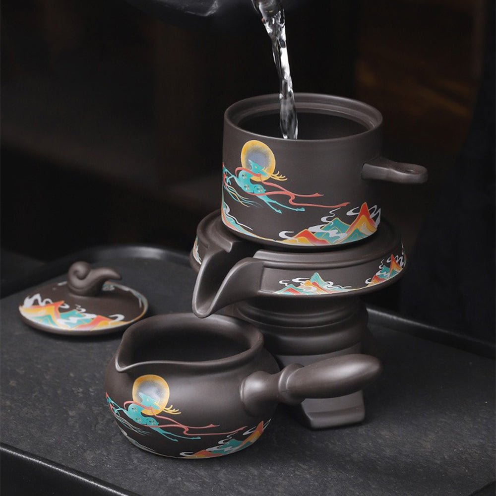 Close-up of the teapot and cups, highlighting the smooth texture of purple clay.