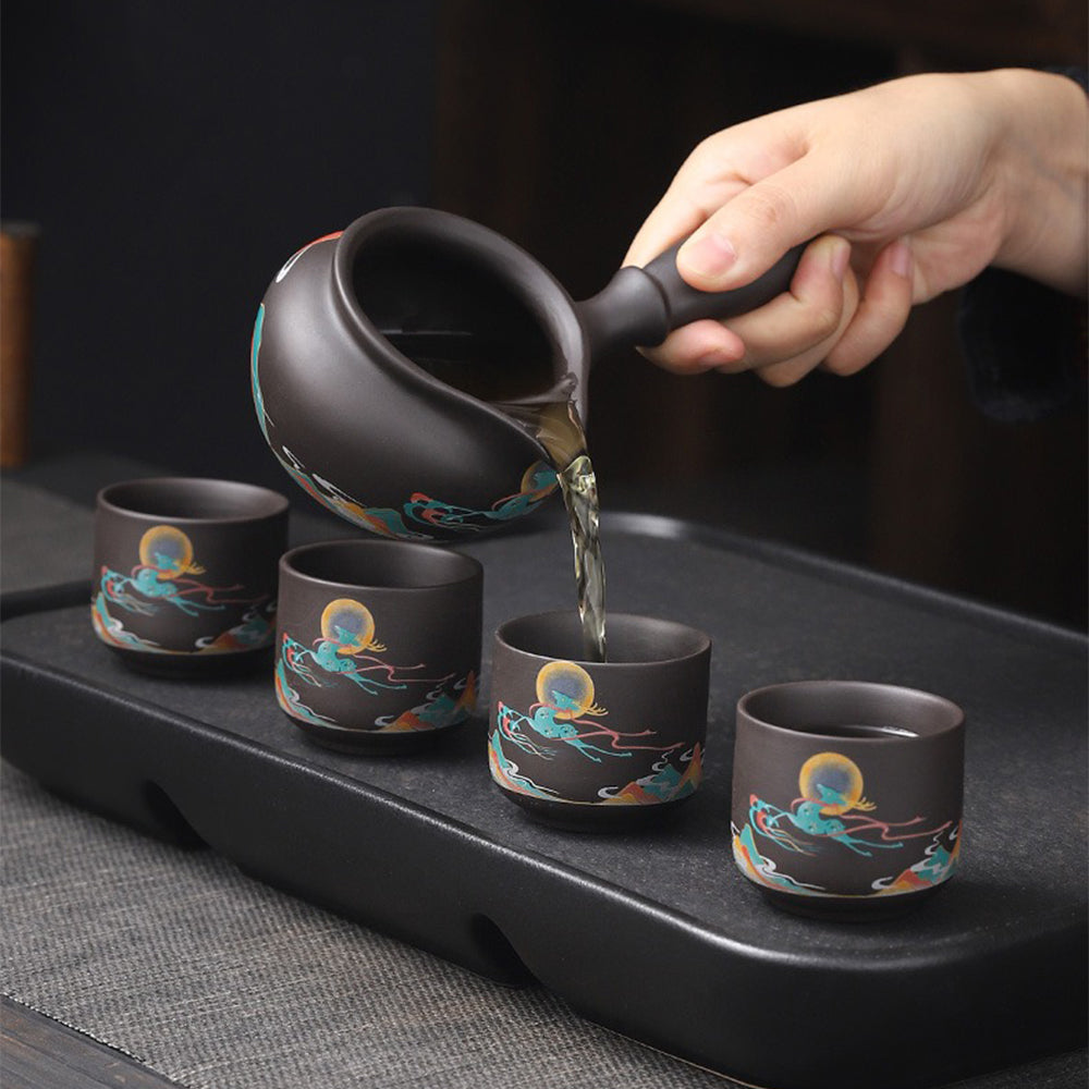 Automatic tea set in action, pouring tea effortlessly into a fair cup.