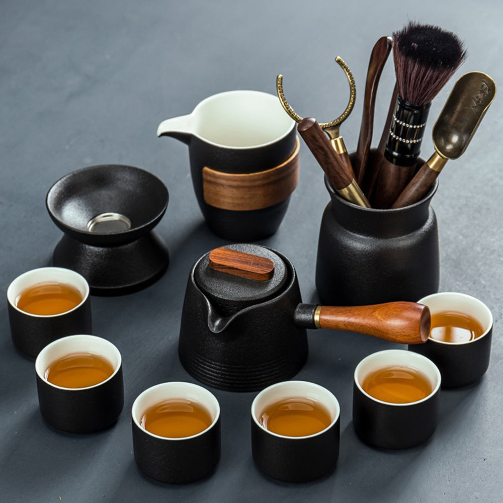 Close-up of black pottery teapot with wooden handle for kung fu tea brewing