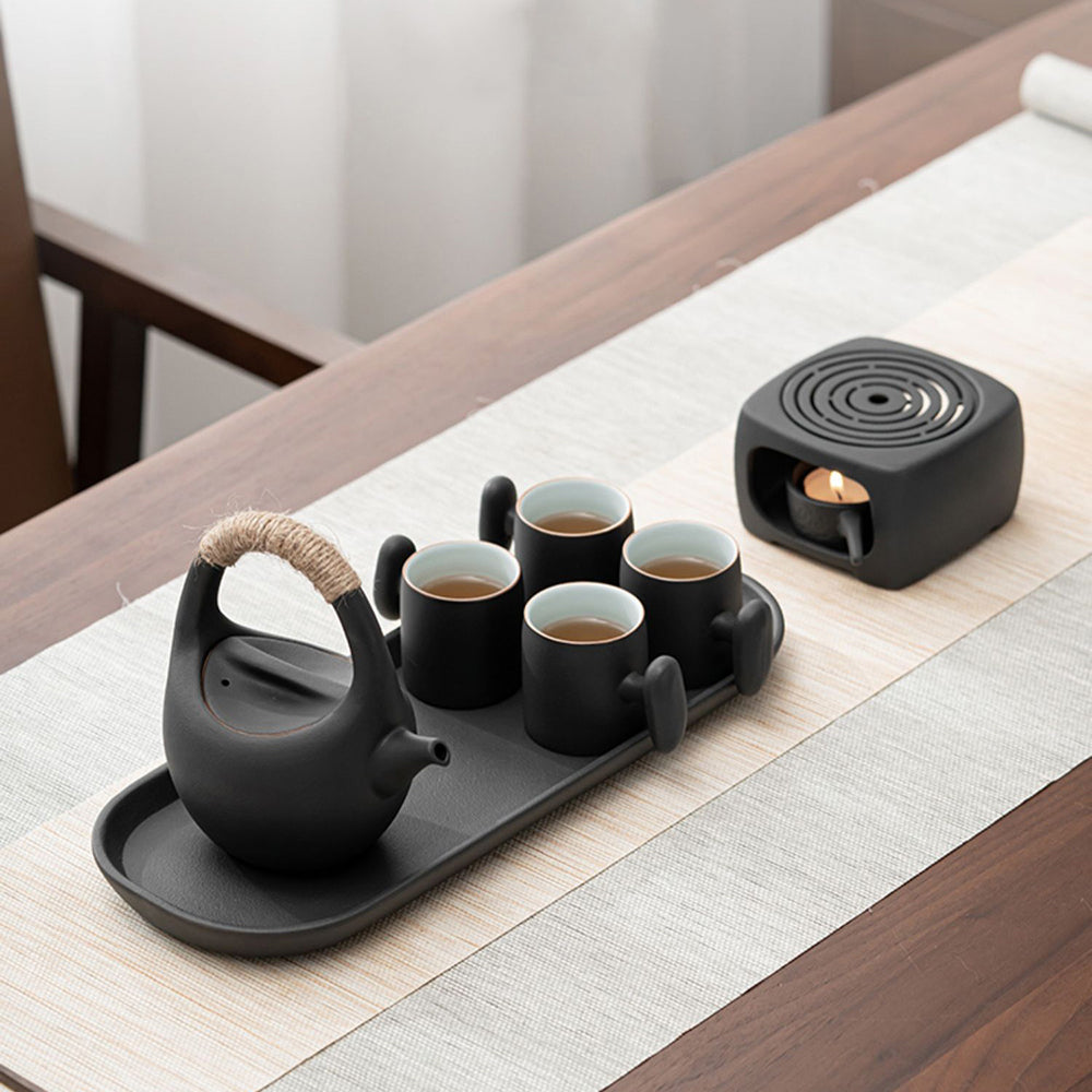 Close-up of the teapot warmer in use, demonstrating its functionality.