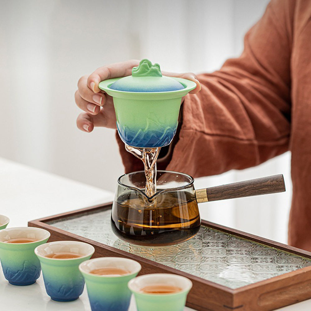Set of six tea cups with blue and green glaze, arranged on a traditional tea tray