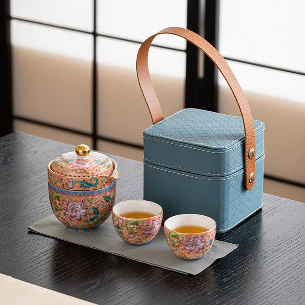 Enamel travel tea set with floral design and leather carrying bag, perfect for tea lovers on the go