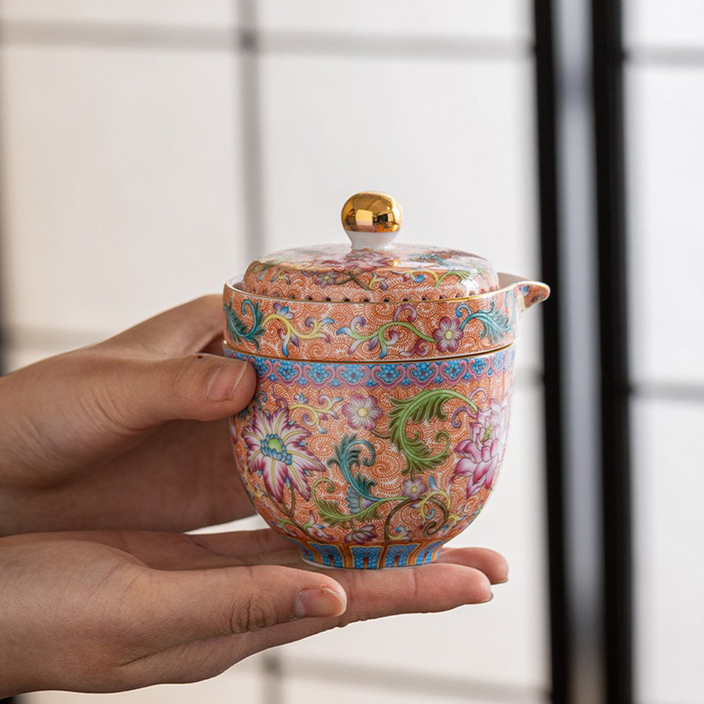 Enamel travel tea set with floral design and leather carrying bag, perfect for tea lovers on the go