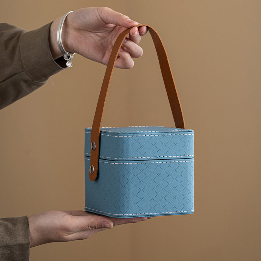 Portable travel tea set featuring a teapot, cups, and waterproof leather bag for easy transport