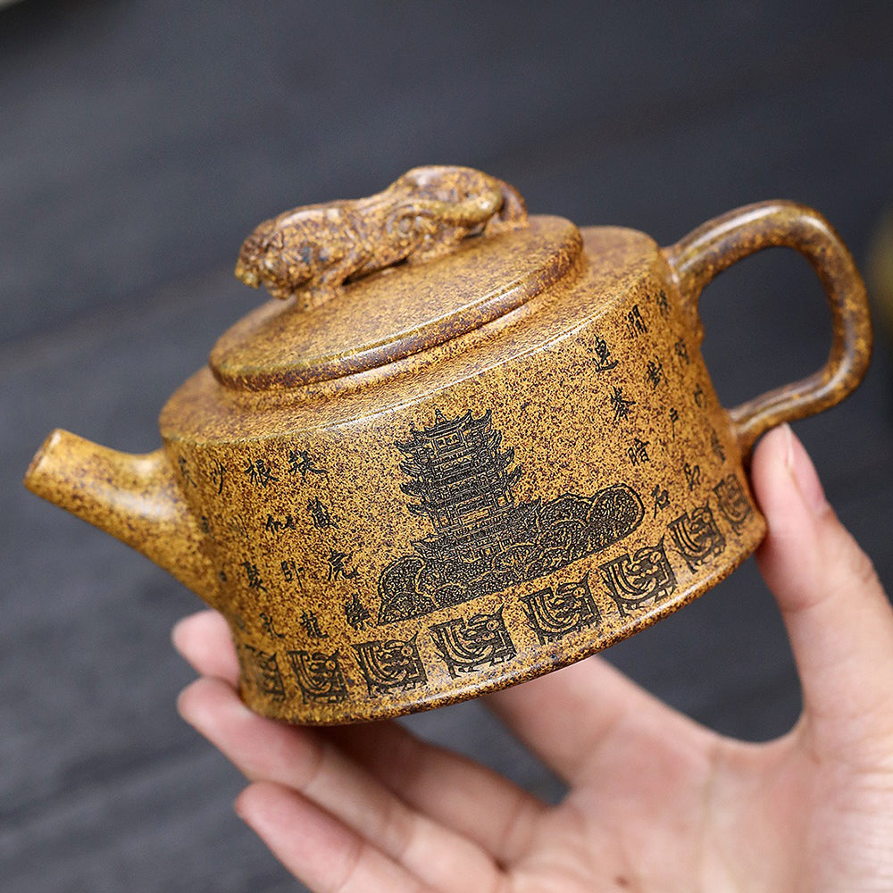 Close-up of the dragon and tiger artwork on the Yixing teapot lid