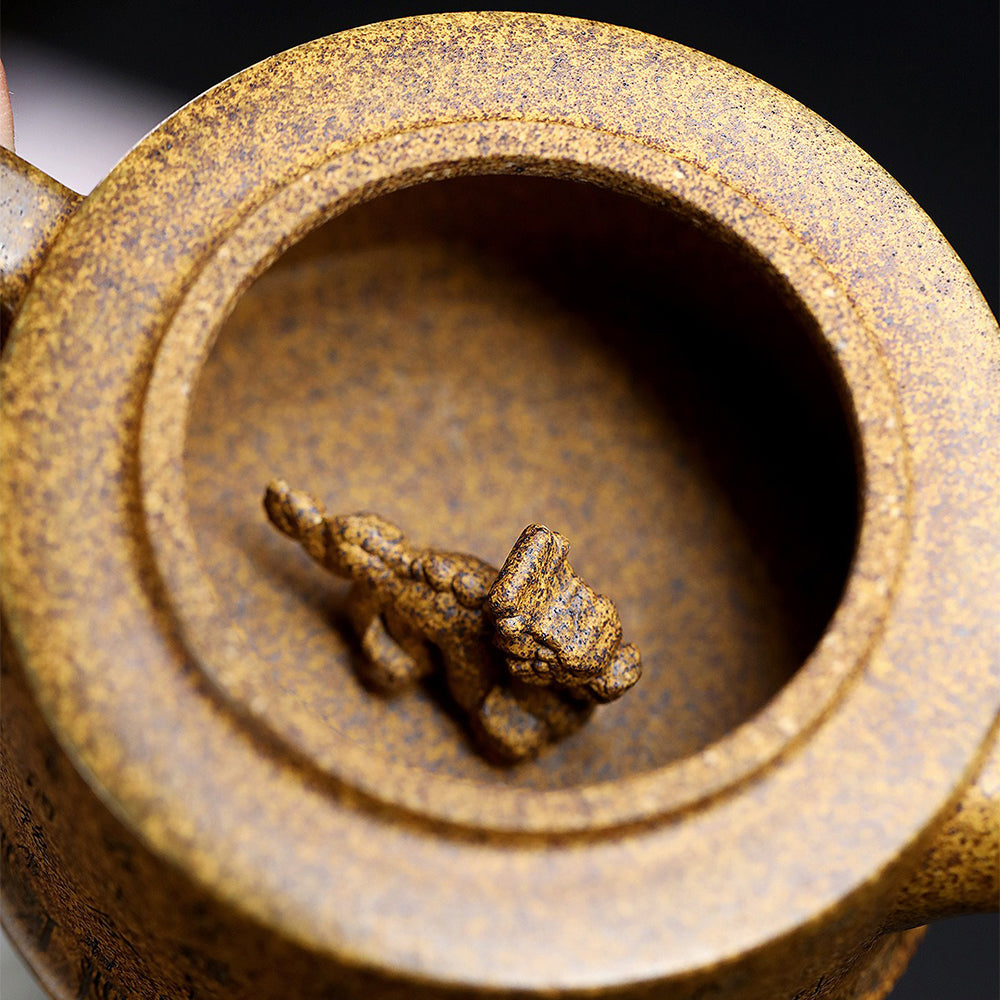 Close-up of the dragon and tiger artwork on the Yixing teapot lid