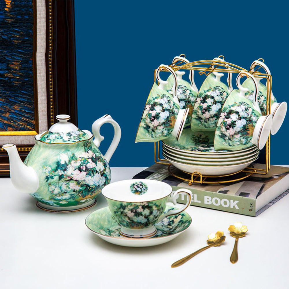 Front view of Van Gogh tea set on wooden shelf, showcasing gold trim and floral design.