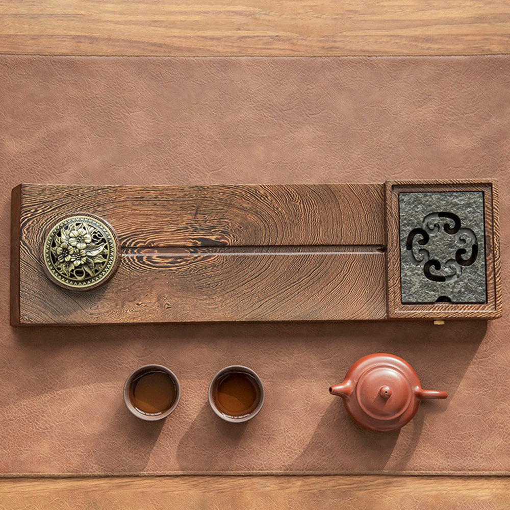 Close-up view of the classical hollow-carved floral design on the incense burner of the tea tray.