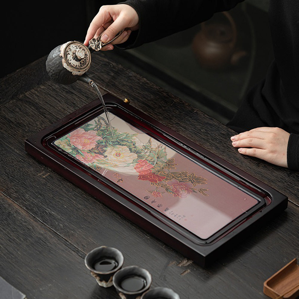 Close-up of the bamboo tea tray highlighting its drainage system and elegant peony design.